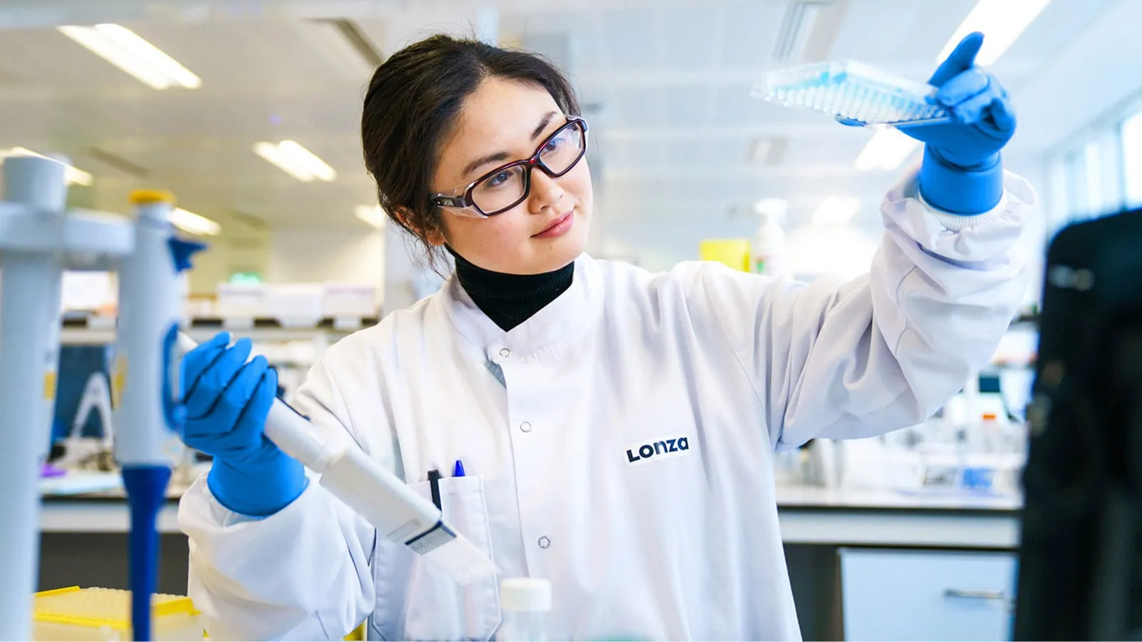 Female Scientist in Lab Inspects Samples